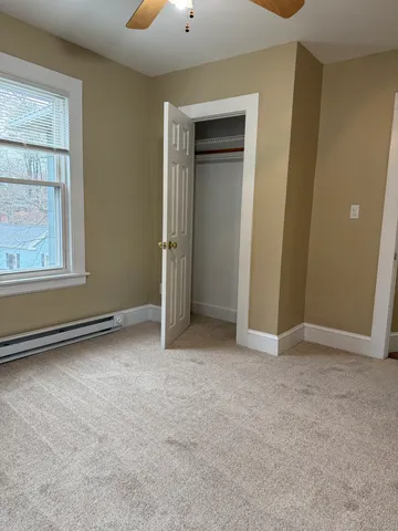 an empty room with windows and closet