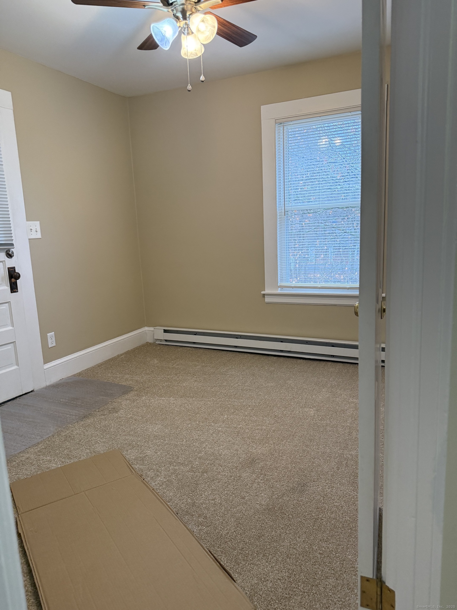 255 Main Street Plymouth, CT 06786 - Photo 12 of 14 an empty room with a chandelier fan and windows