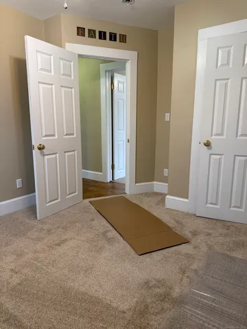 an empty room with closet and mirror
