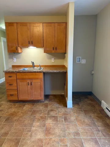 a kitchen with a sink a stove and cabinets