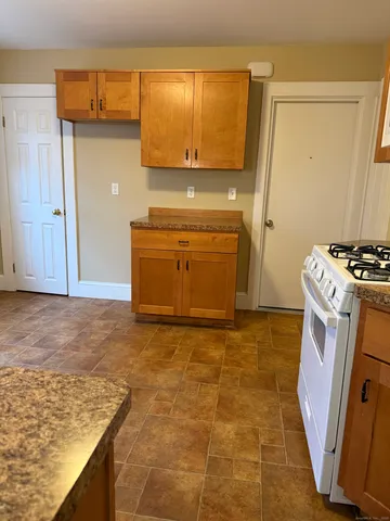 a kitchen with a stove and a refrigerator