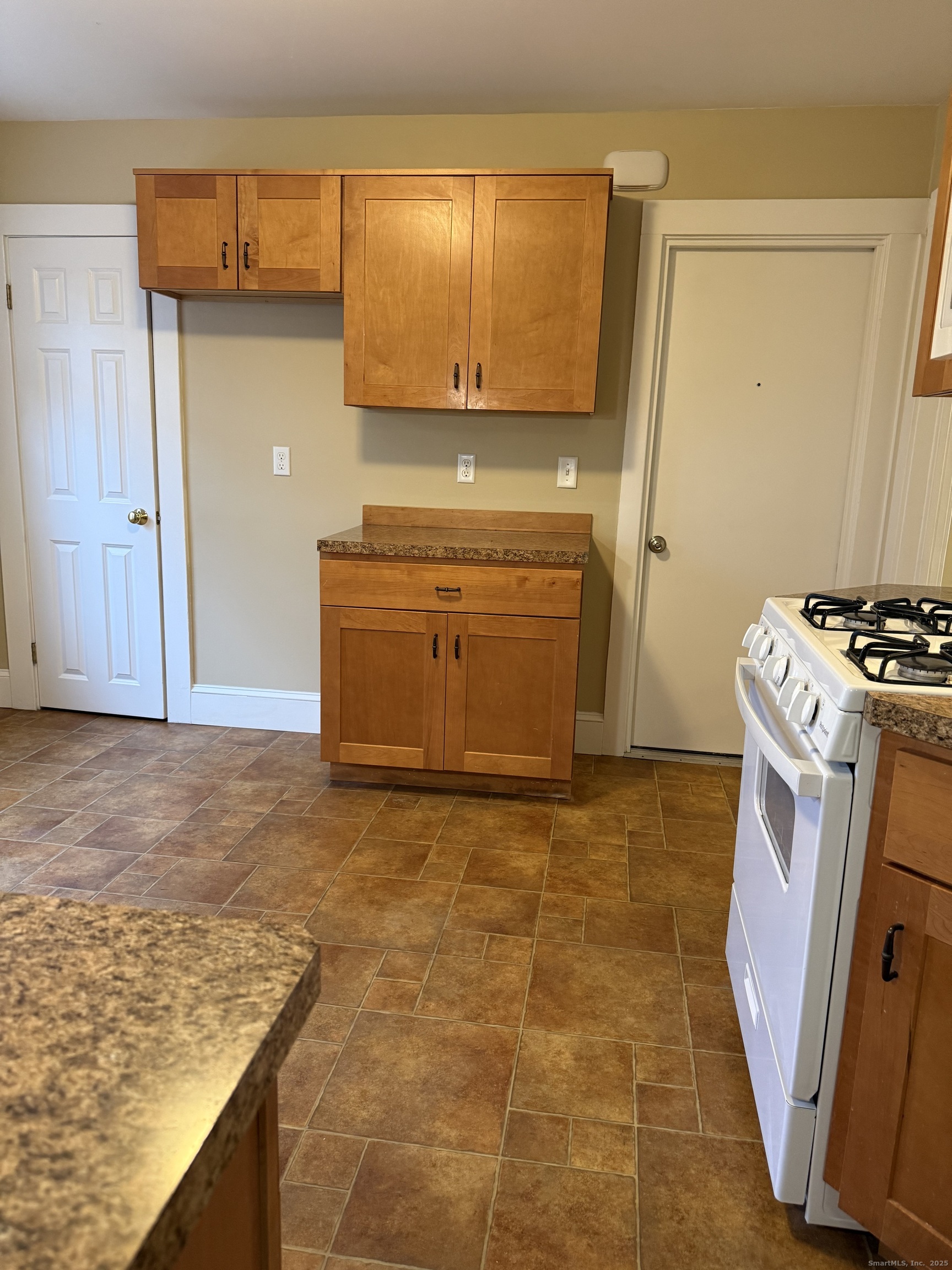 255 Main Street Plymouth, CT 06786 - Photo 3 of 14 a kitchen with a stove and a refrigerator
