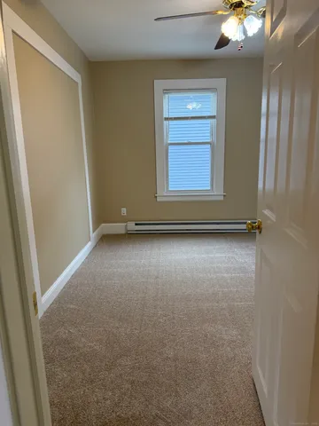 an empty room with windows and closet