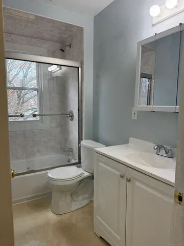 a bathroom with a sink a toilet and a shower