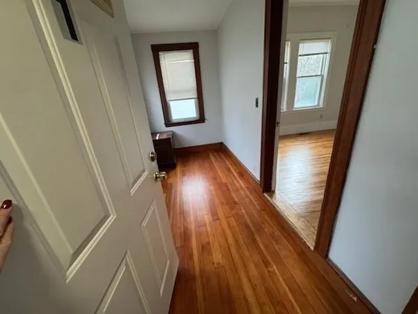 a view of an entryway with wooden floor