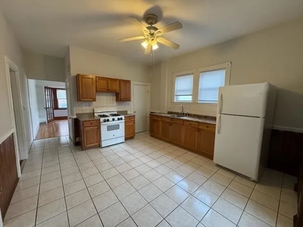 a kitchen with a refrigerator a stove top oven and kitchen island