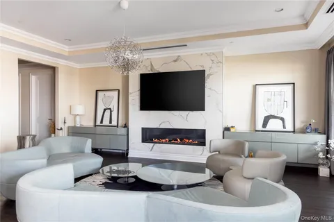 a living room with furniture a fireplace and a flat screen tv