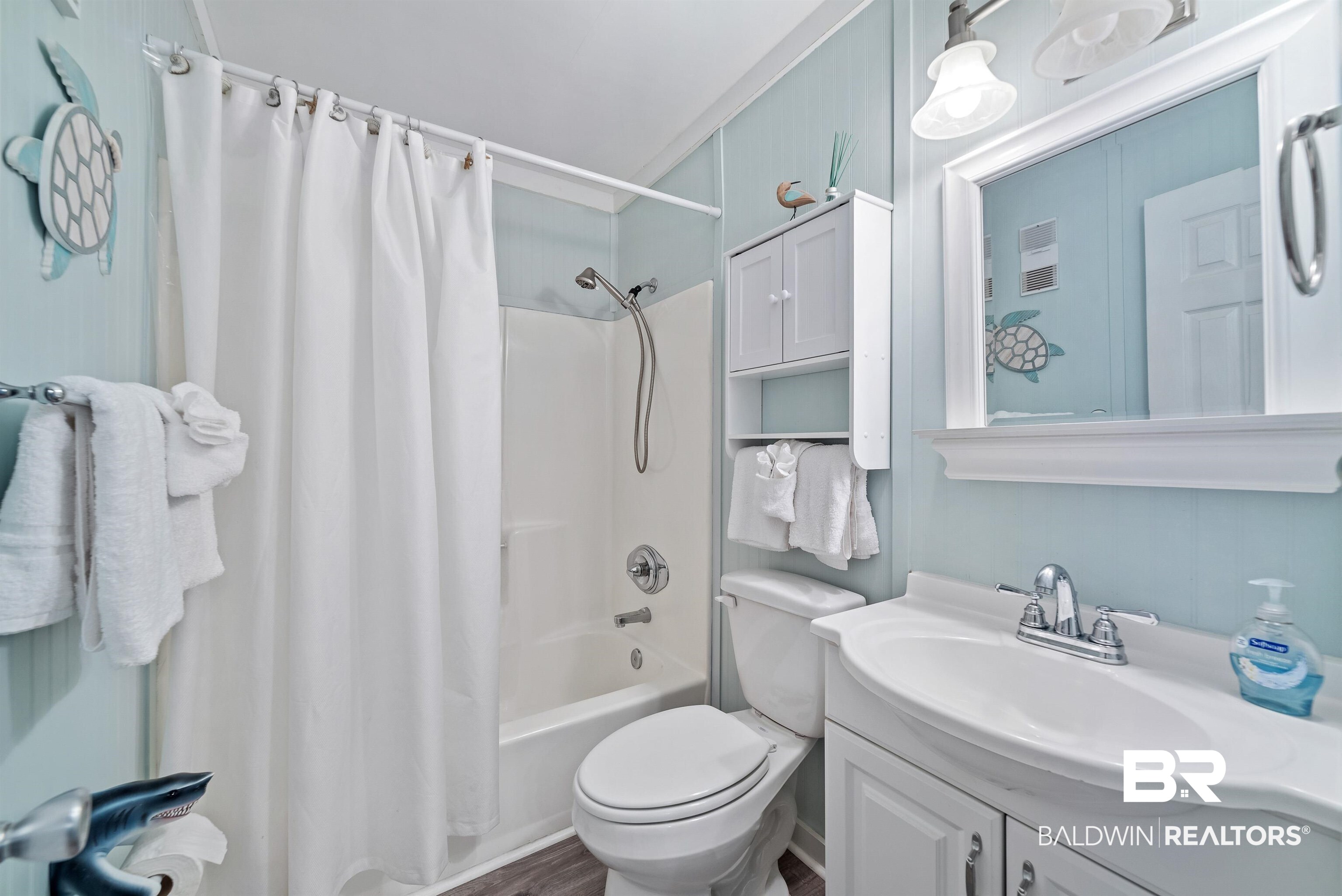 400 Plantation Road, Unit 2123 Gulf Shores, AL 36542 - Photo 19 of 44 Full bathroom with hardwood / wood-style floors, vanity, shower / bathtub combination with curtain, and toilet