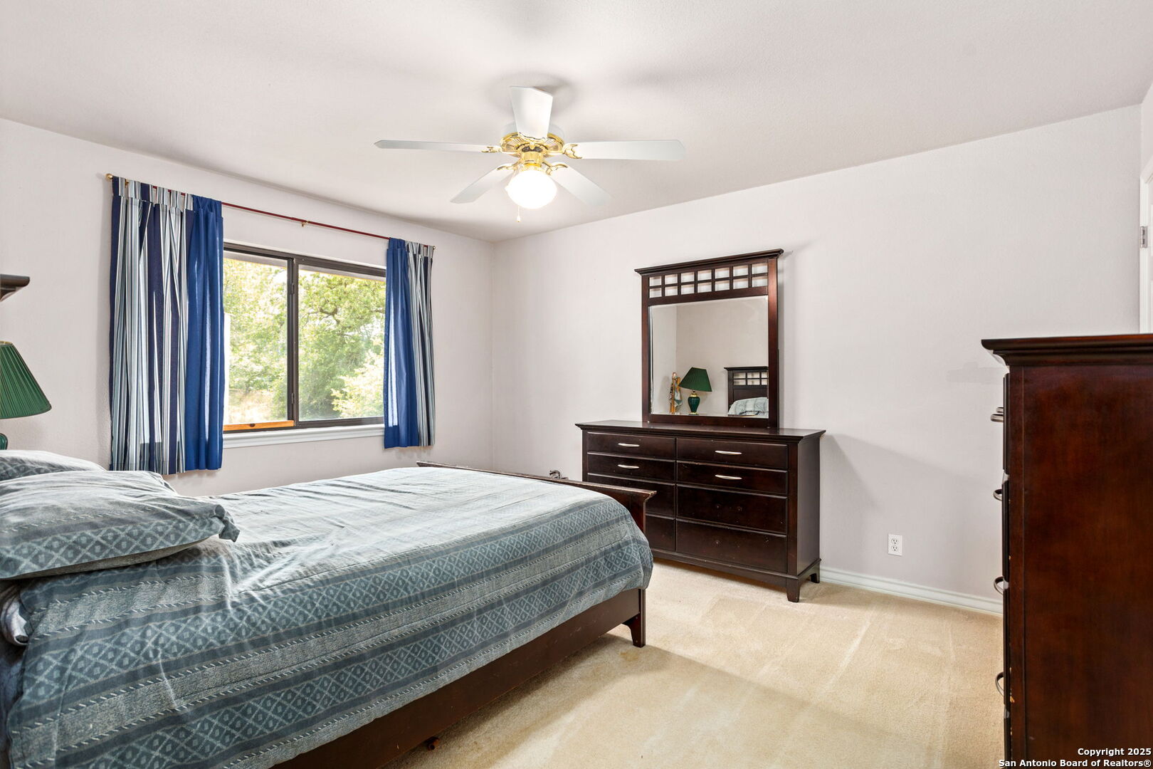 20-acres Guadalupe Ranch Lane Seguin, TX 78155 - Photo 24 of 40 a bedroom with a bed and a chandelier