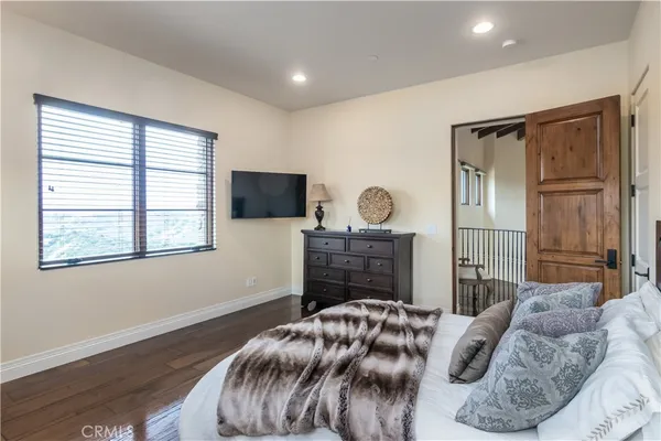 a bedroom with a bed and a mirror