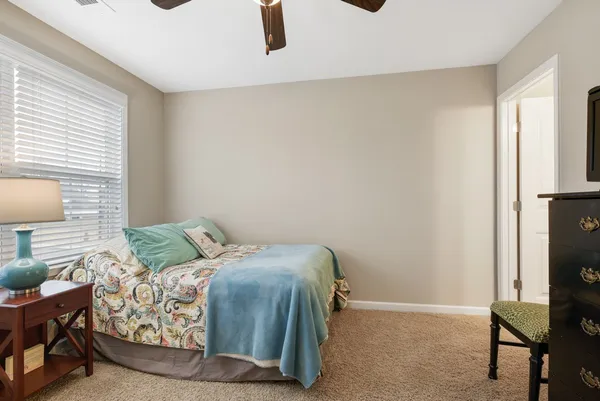 a bedroom with a bed and chair
