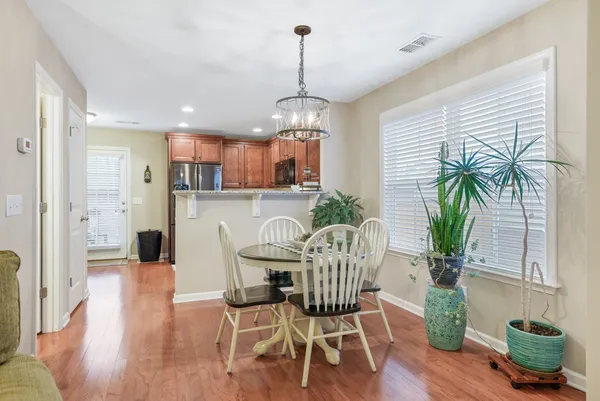 a view of a dining room with furniture window and wooden floor