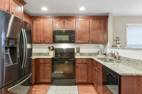 a kitchen with a sink stove and refrigerator