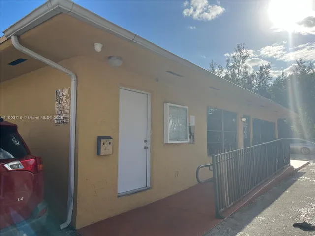 a swimming pool with lots of green space and trees in the background