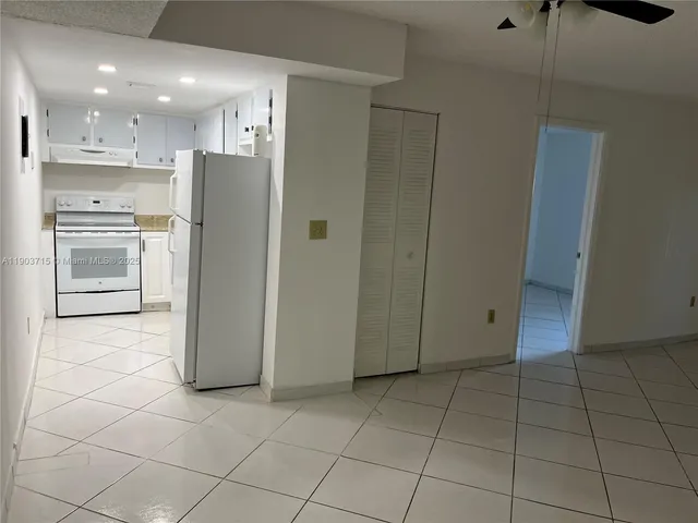 a view of a kitchen with refrigerator and microwave