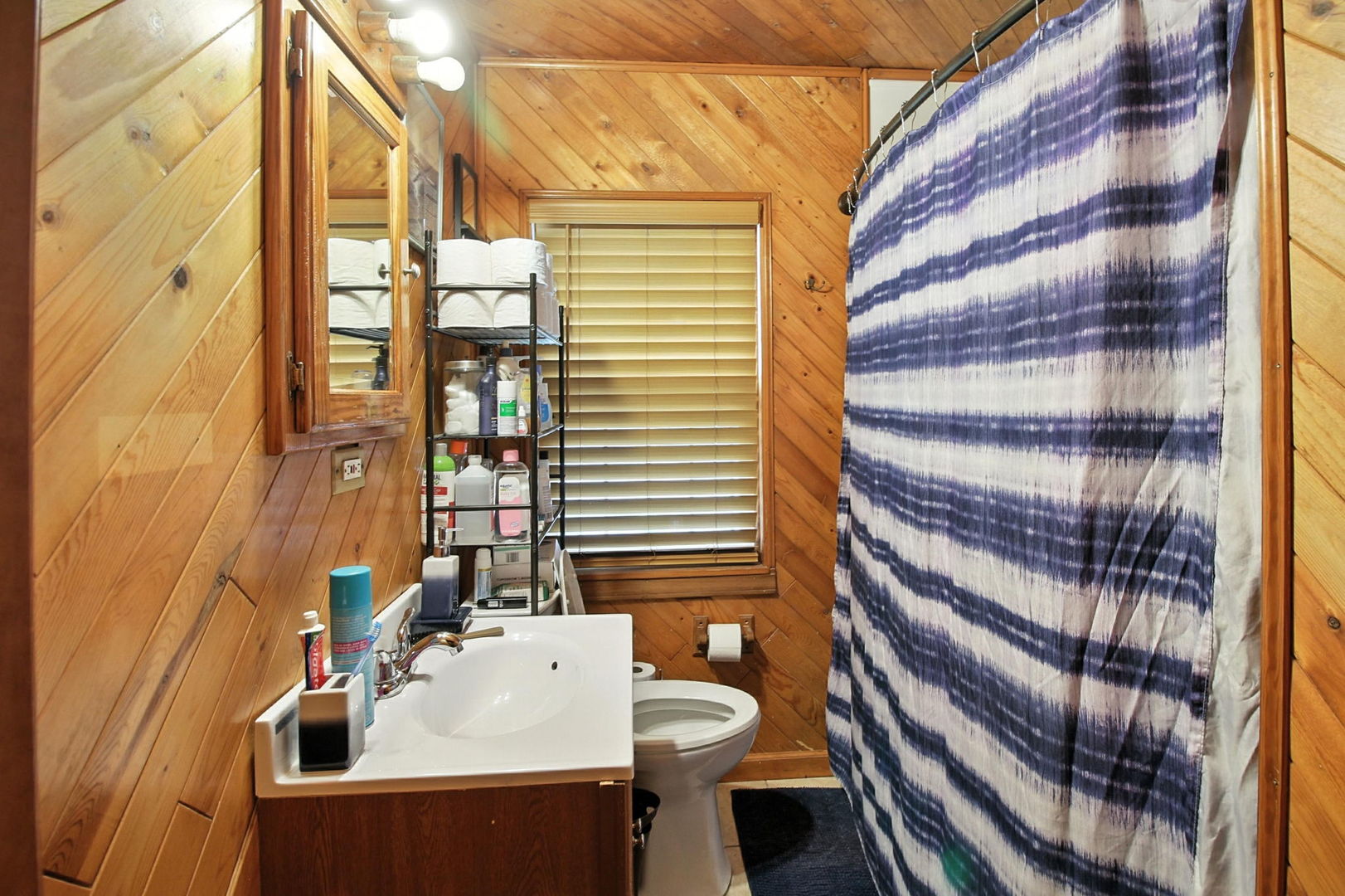 818 Morgan Street Joliet, IL 60436 - Photo 8 of 22 a bathroom with a sink a toilet and shower curtain