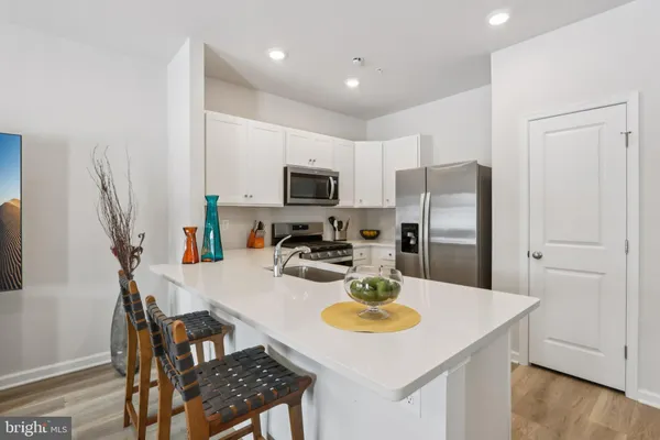 a kitchen with a dining table and chairs