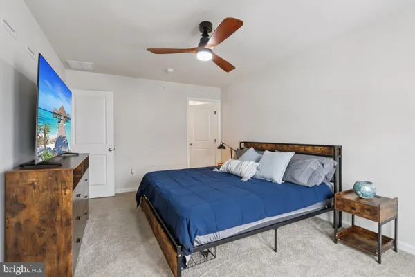 a bedroom with a bed and a couch