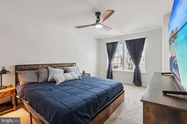 a bed sitting in a bedroom next to a window