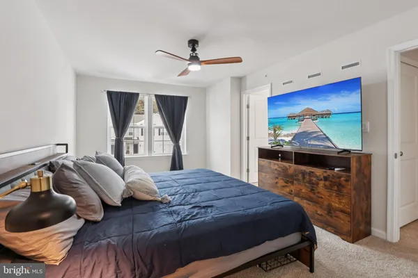 a bedroom with a bed and a balcony