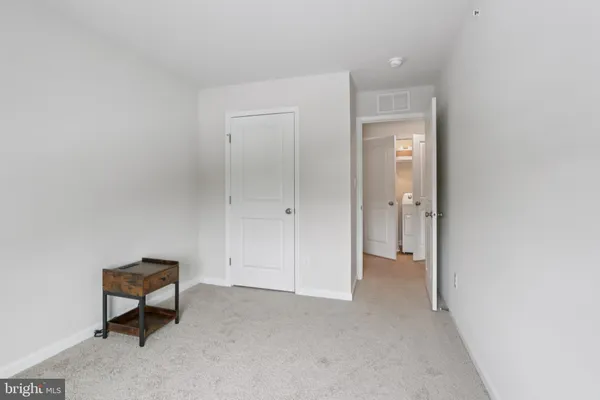 a view of a livingroom with a bench and a cabinet