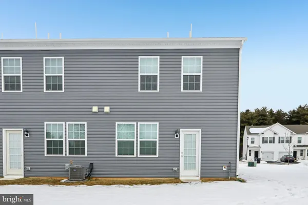 a front view of a house with a road