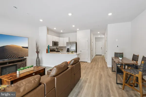 a living room with furniture and kitchen view