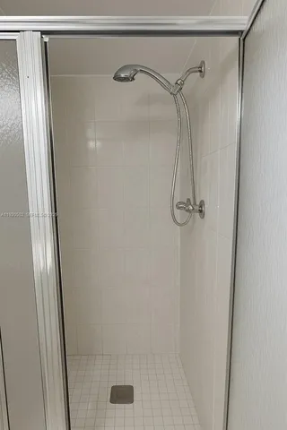 a bathroom with a glass shower door