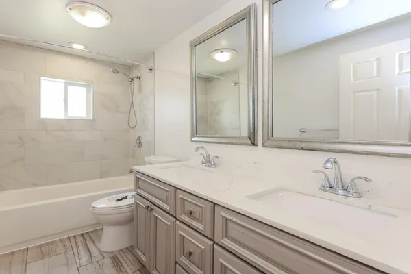 a bathroom with a sink a toilet and a mirror