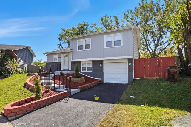a view of a house with backyard and sitting area