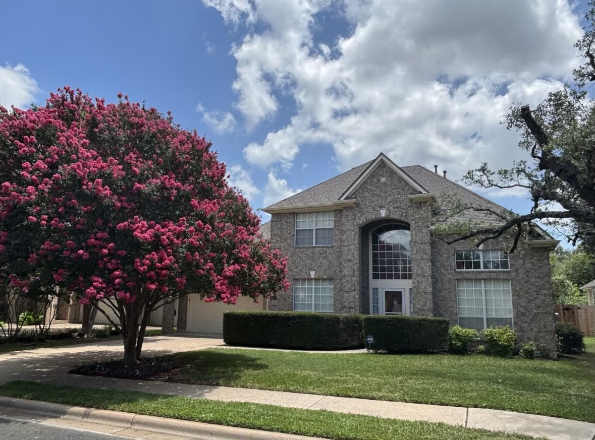 9439 Altona Way Austin, TX 78717 - Photo 1 of 40 a front view of a house with a garden