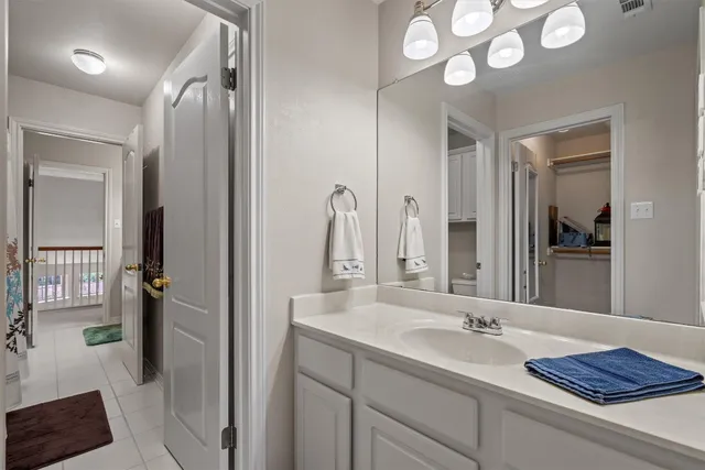 a bathroom with a granite countertop sink a mirror and a shower