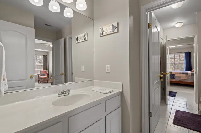a en suite bathroom with a sink and a mirror