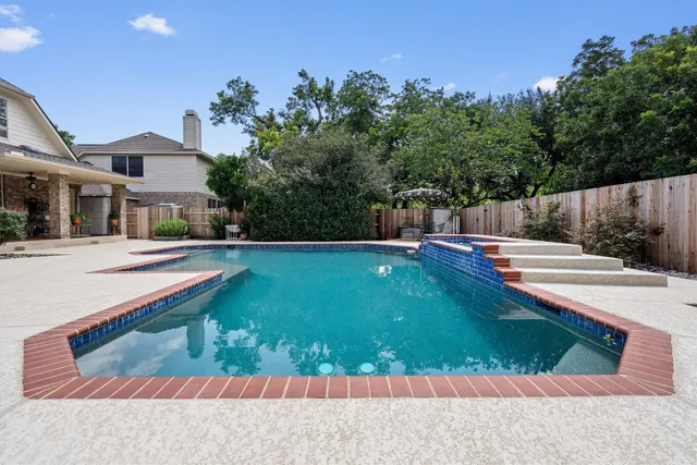 a swimming pool with outdoor seating and yard