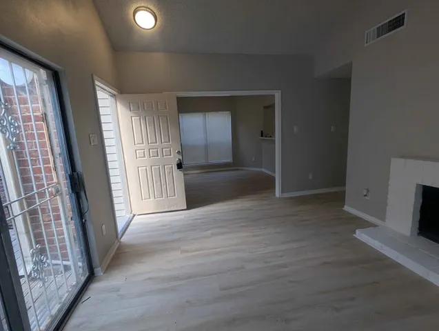 wooden floor in an empty room with a fireplace
