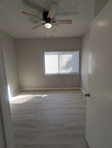 en empty room with window and fan