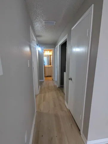 a view of hallway with wooden floor