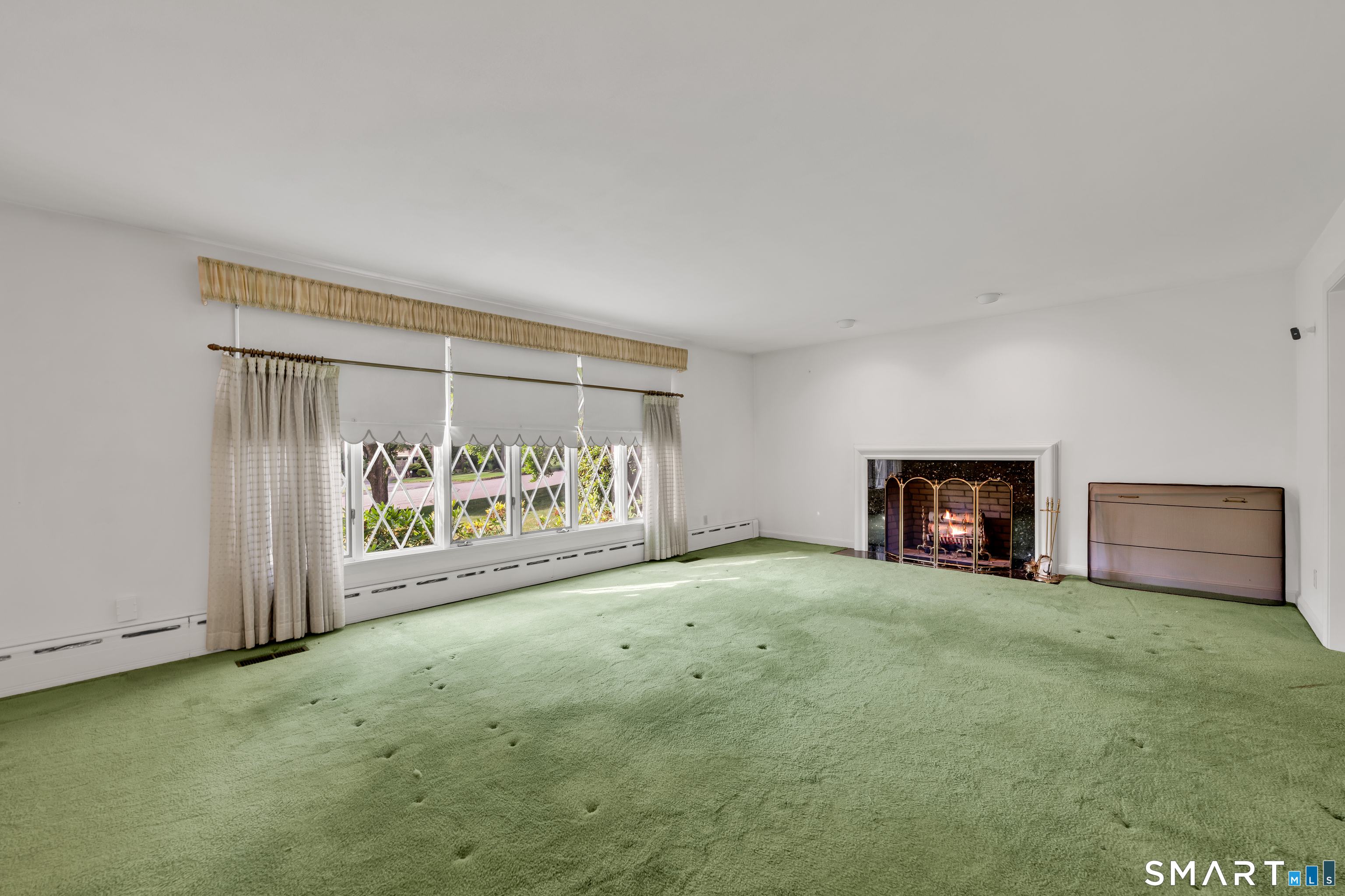 232 Maybrook Road Waterbury, CT 06708 - Photo 17 of 38 a view of an empty room with a fireplace and a window