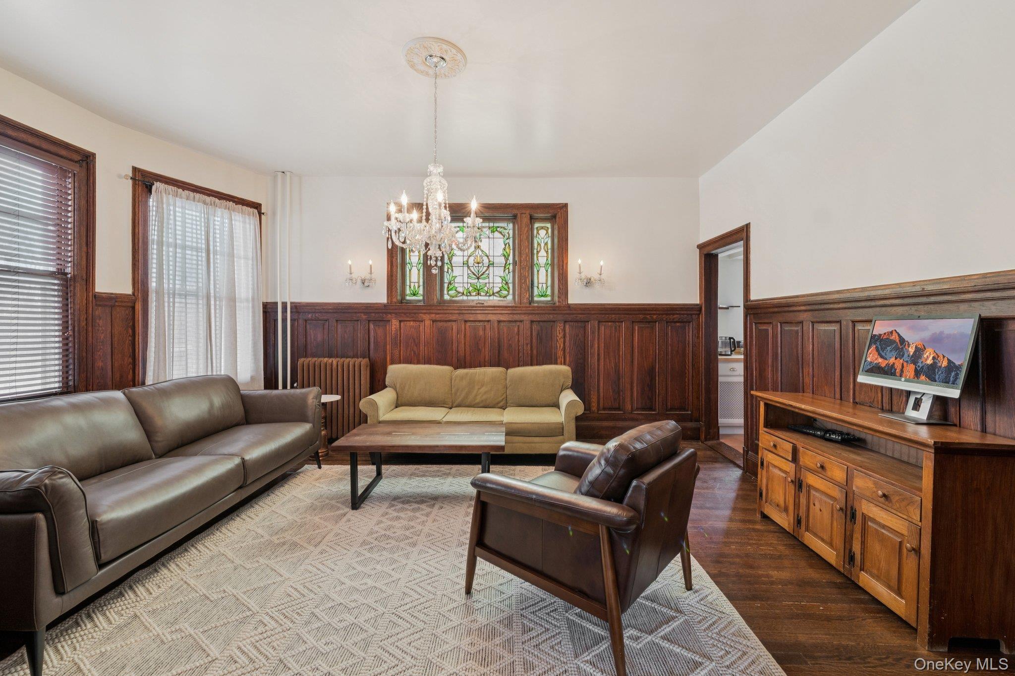 397 Split Rock Road Syosset, NY 11791 - Photo 12 of 29 a living room with furniture and a chandelier