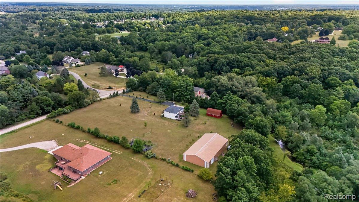 7330 West Gates Street Romeo, MI 48065 - Photo 64 of 73 Expansive property featuring multiple structures, including a primary residence with a large deck, a detached outbuilding, and a red barn