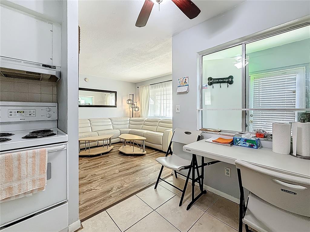 250 Rosery Road Northwest, Unit 228 Largo, FL 33770 - Photo 12 of 27 a kitchen with a sink a stove and white cabinets