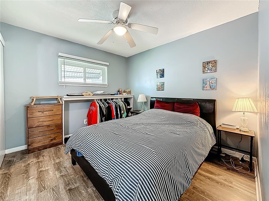 250 Rosery Road Northwest, Unit 228 Largo, FL 33770 - Photo 16 of 27 a bed room with a bed and a walk in closet