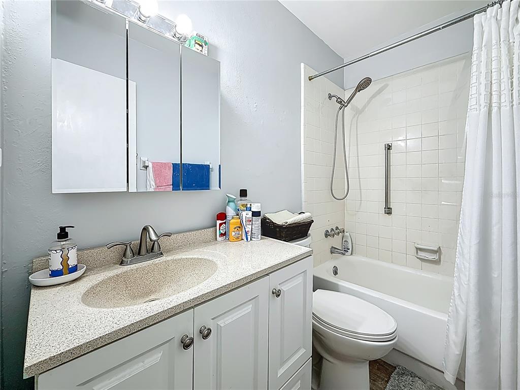 250 Rosery Road Northwest, Unit 228 Largo, FL 33770 - Photo 19 of 27 a bathroom with a sink toilet tub and shower