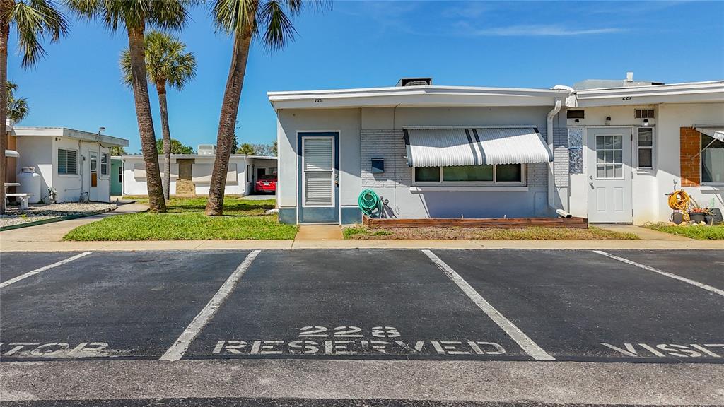 250 Rosery Road Northwest, Unit 228 Largo, FL 33770 - Photo 2 of 27 a view of a building with car parked