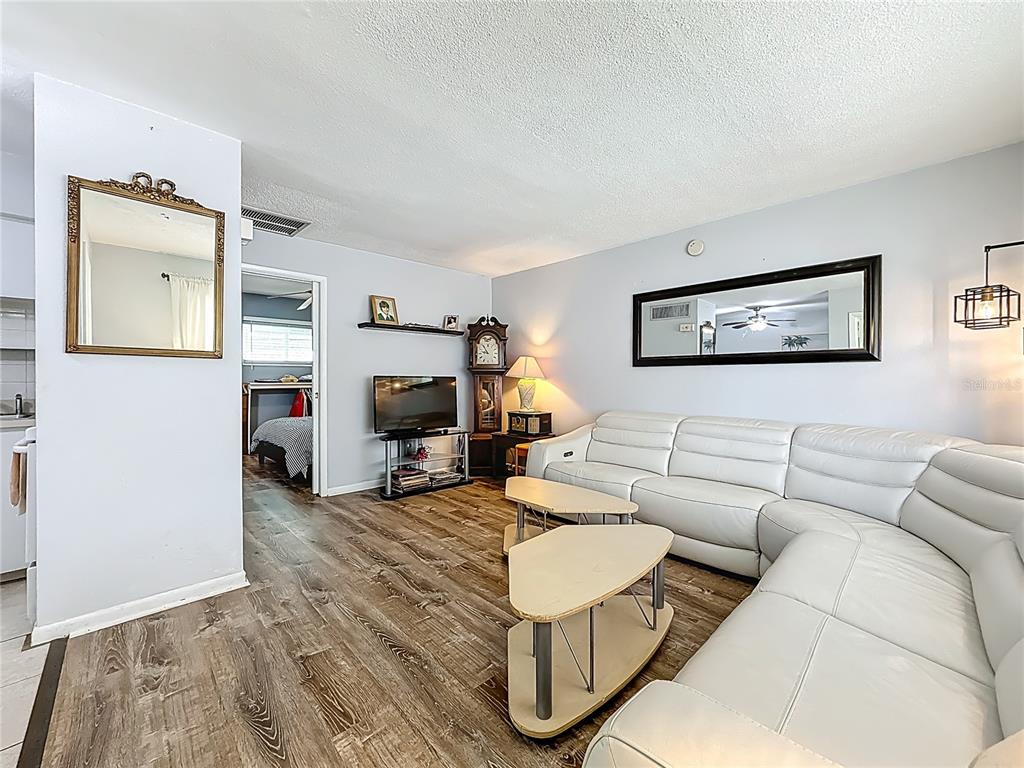 250 Rosery Road Northwest, Unit 228 Largo, FL 33770 - Photo 5 of 27 a living room with furniture and a fireplace