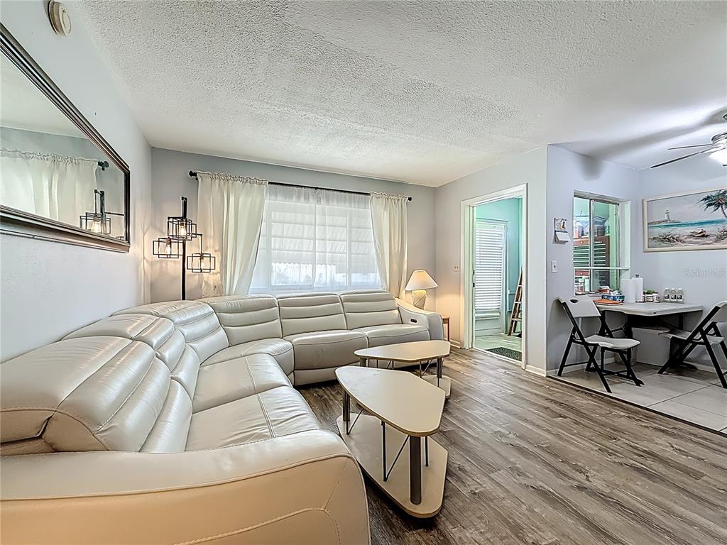 250 Rosery Road Northwest, Unit 228 Largo, FL 33770 - Photo 8 of 27 a living room with furniture and wooden floor