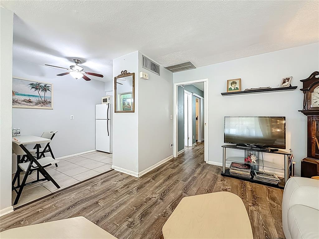 250 Rosery Road Northwest, Unit 228 Largo, FL 33770 - Photo 9 of 27 a living room with furniture and a flat screen tv