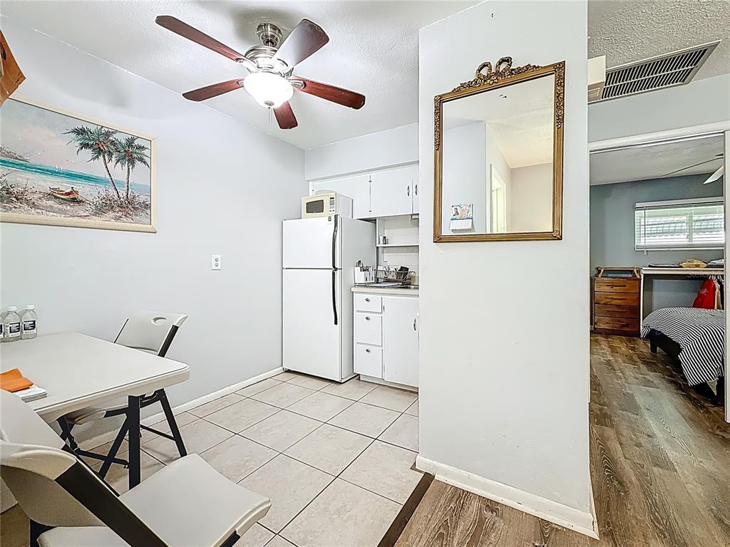 250 Rosery Road Northwest, Unit 228 Largo, FL 33770 - Photo 10 of 27 a kitchen with stainless steel appliances kitchen island granite countertop a refrigerator and a stove