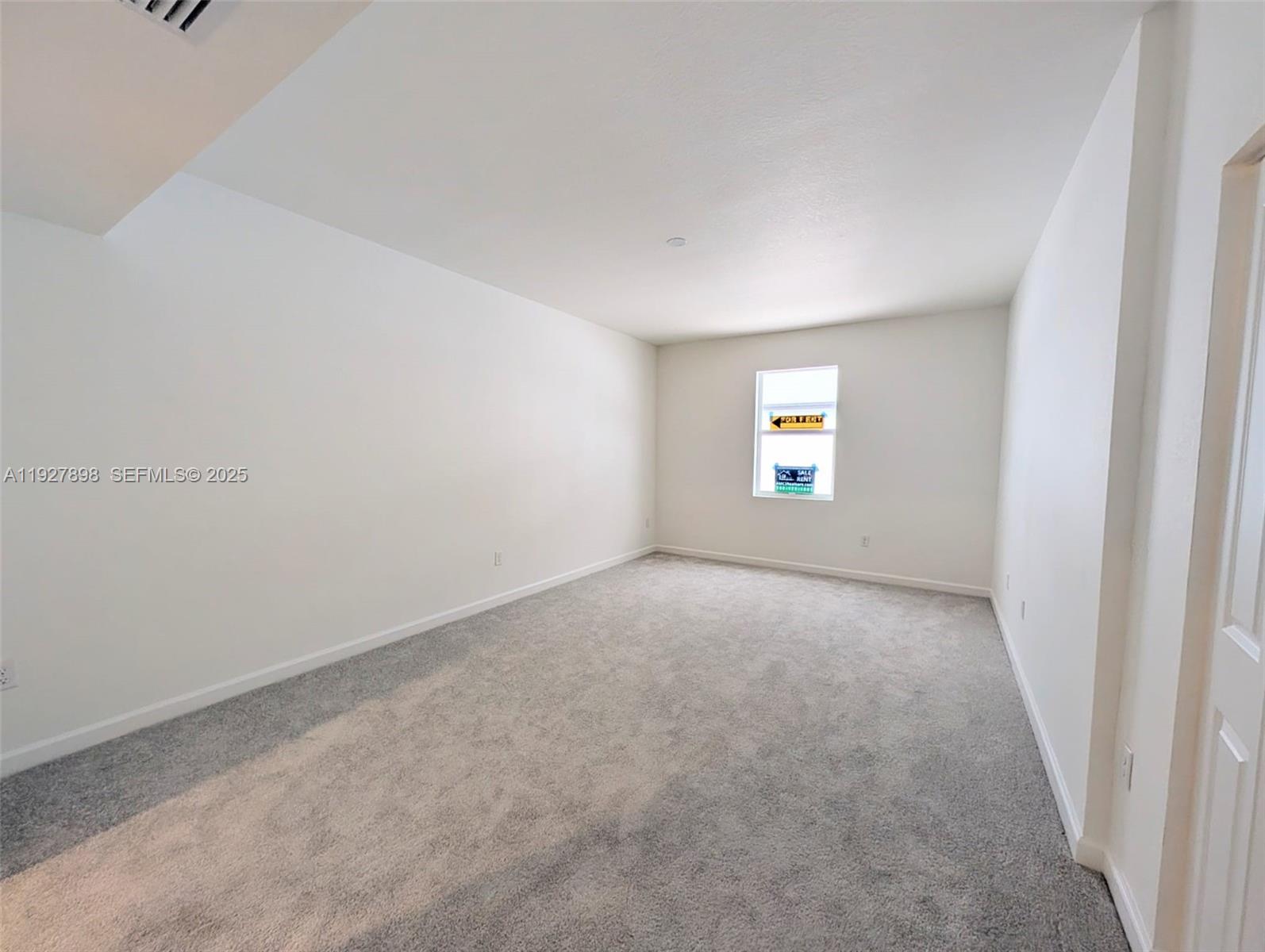 15557 Southwest 280th Street, Unit 4 Homestead, FL 33032 - Photo 5 of 8 an empty room with windows