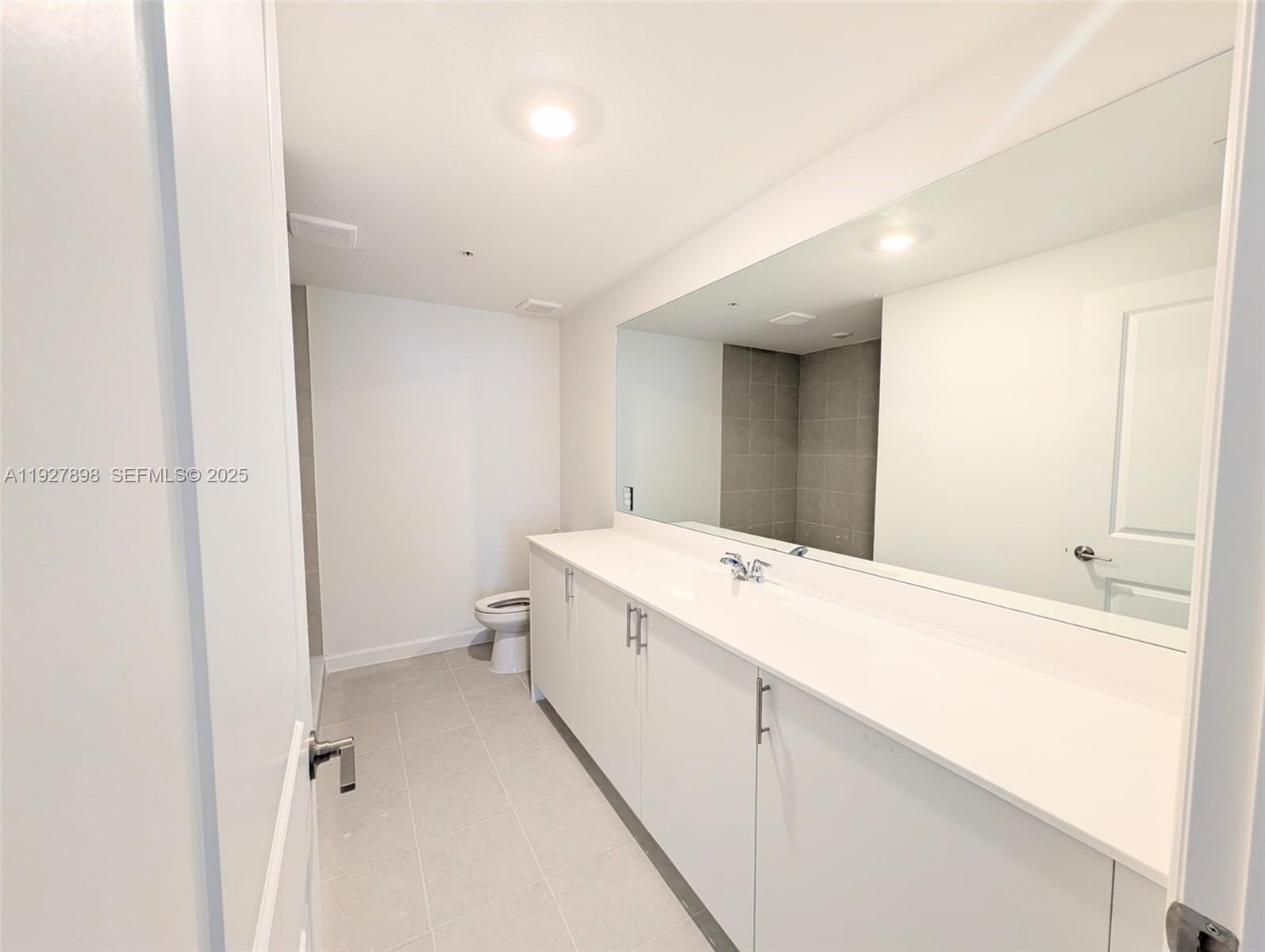 15557 Southwest 280th Street, Unit 4 Homestead, FL 33032 - Photo 6 of 8 a bathroom with a sink a toilet and shower